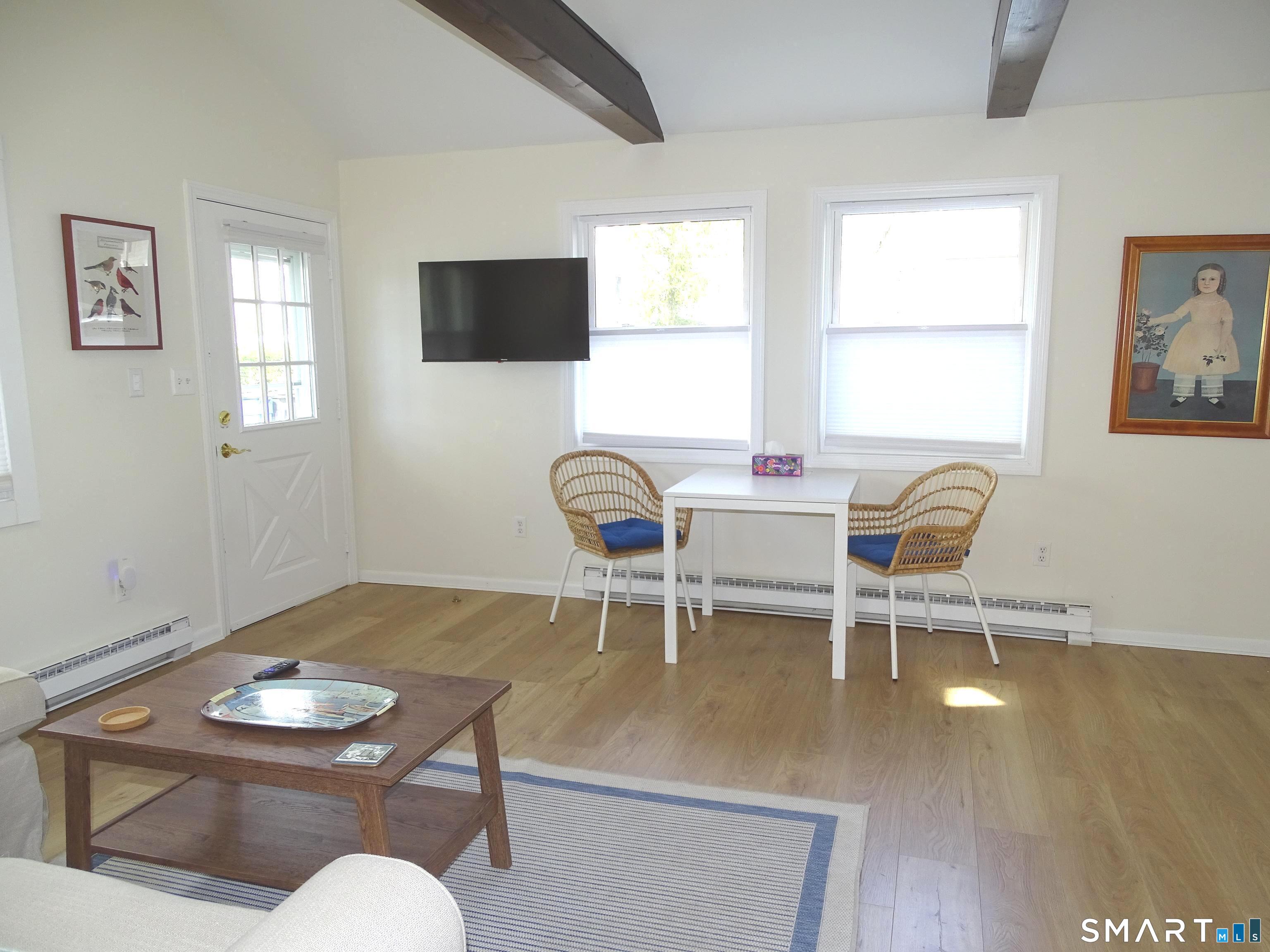 81 Church Street Branford, CT 06405 - Photo 7 of 21 a living room with furniture a flat screen tv and windows