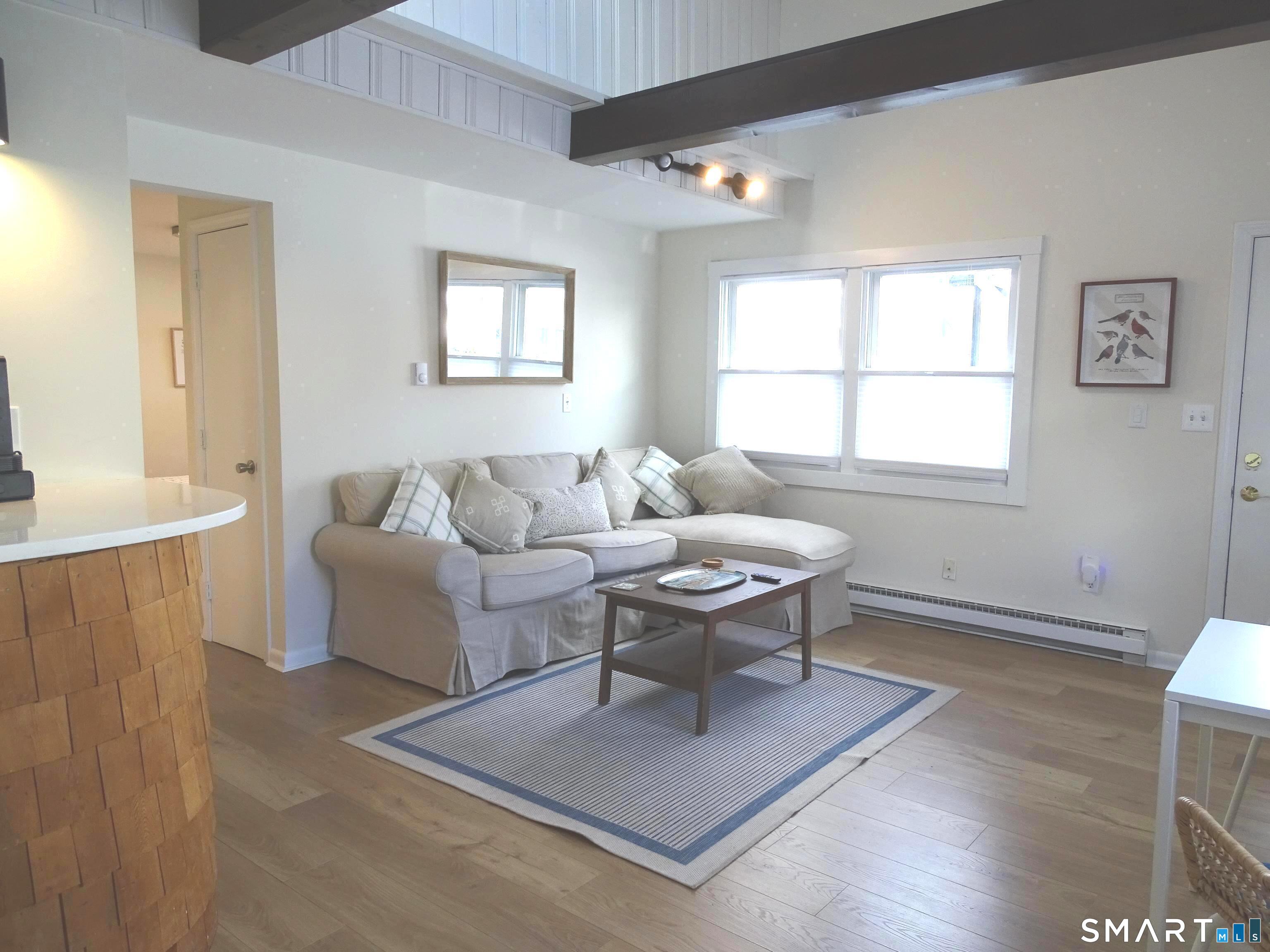 81 Church Street Branford, CT 06405 - Photo 10 of 21 a living room with furniture a table and a window