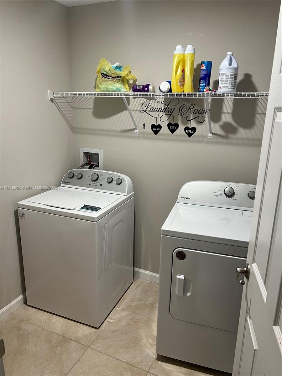 172 Southwest Langfield Avenue Port St. Lucie, FL 34984 - Photo 22 of 24 a utility room with dryer and washer
