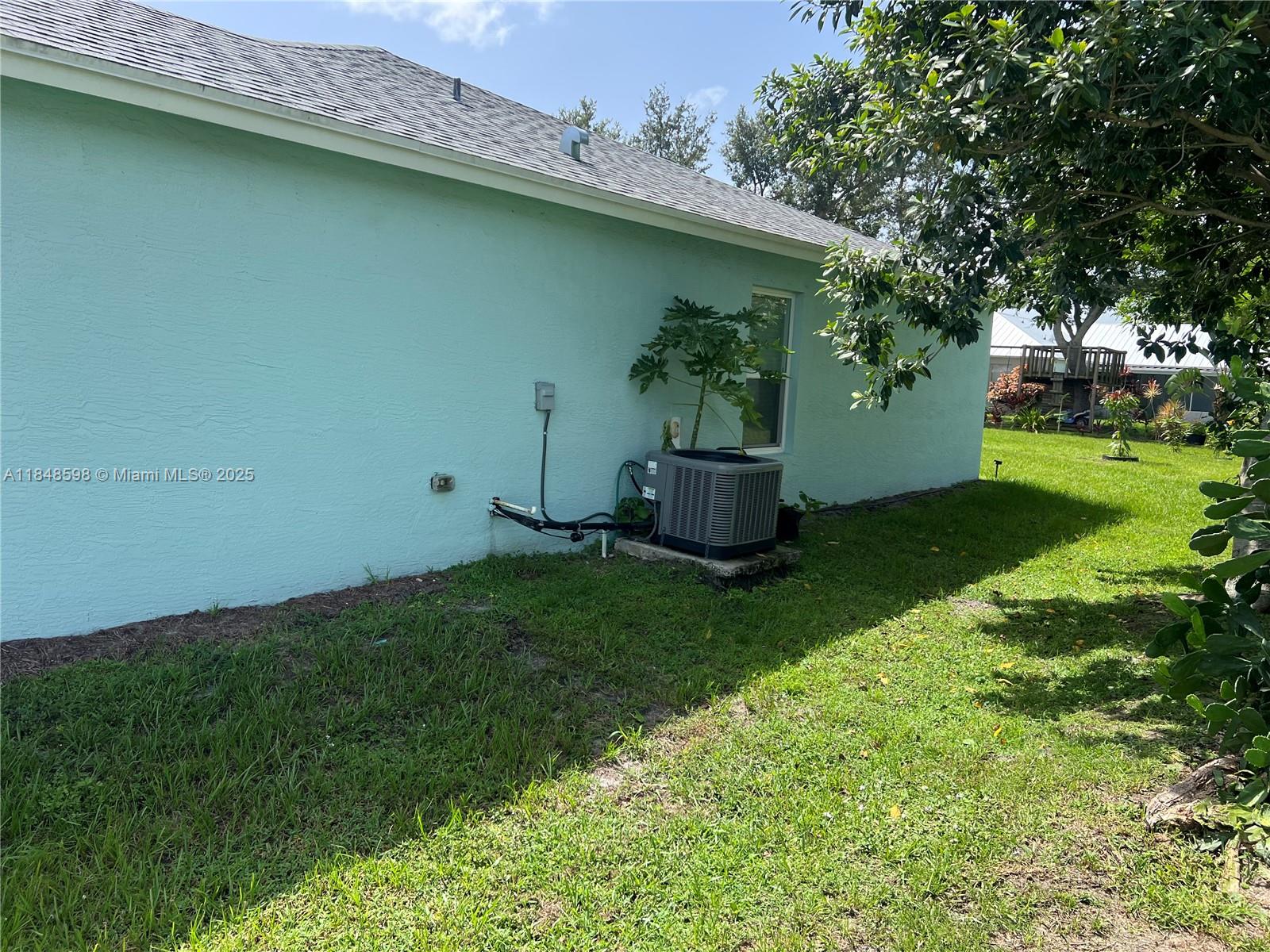 172 Southwest Langfield Avenue Port St. Lucie, FL 34984 - Photo 23 of 24 a view of backyard with outdoor seating and green space