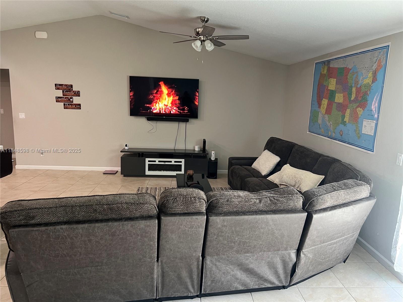 172 Southwest Langfield Avenue Port St. Lucie, FL 34984 - Photo 5 of 24 a living room with furniture and a flat screen tv