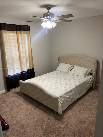 a large bed sitting in a bedroom next to a window