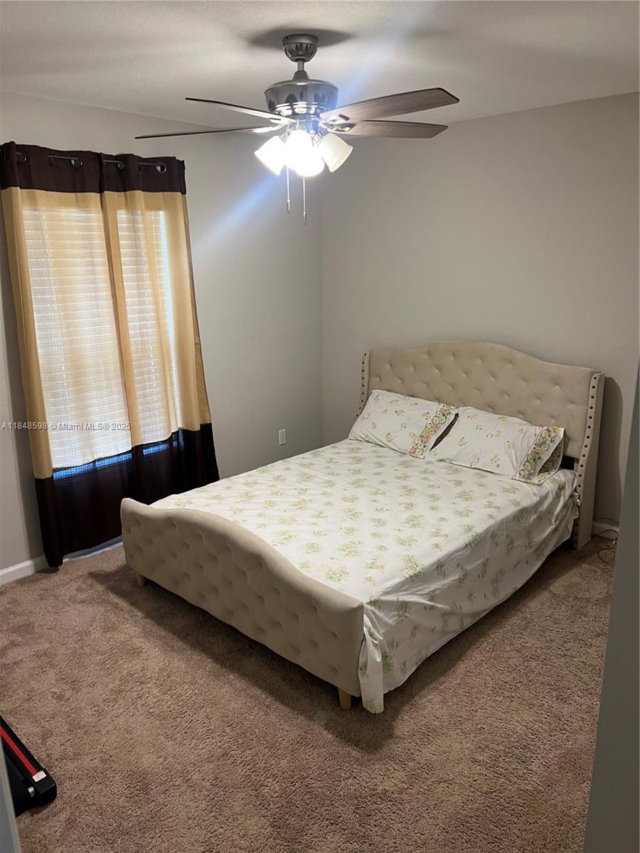 172 Southwest Langfield Avenue Port St. Lucie, FL 34984 - Photo 7 of 24 a bedroom with a bed and window