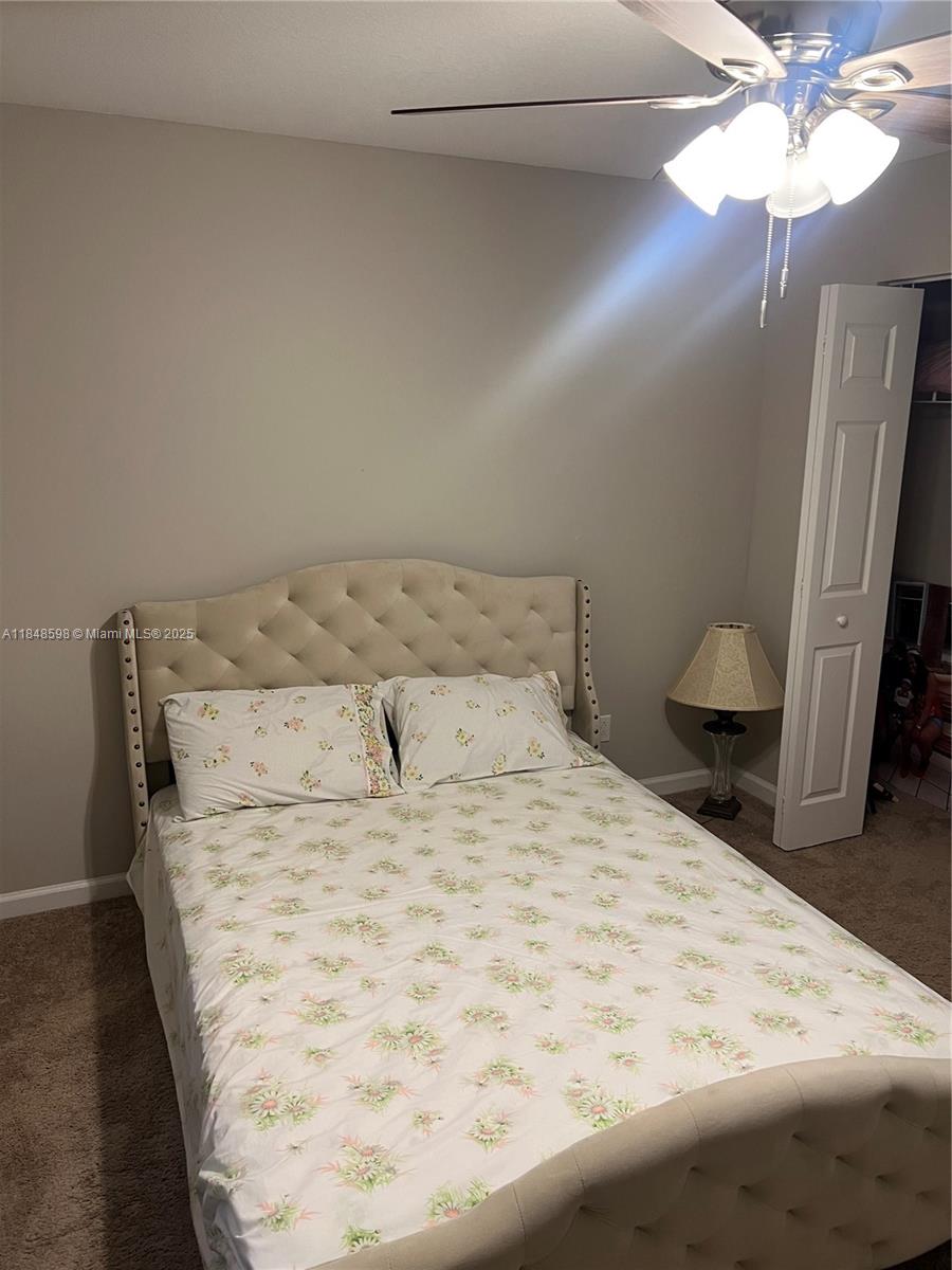 172 Southwest Langfield Avenue Port St. Lucie, FL 34984 - Photo 8 of 24 a large bed sitting in a bedroom next to a window