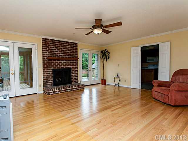 365 Gregory Road Salisbury, NC 28147 - Photo 2 of 16 a view of a livingroom with a fireplace a ceiling fan and windows