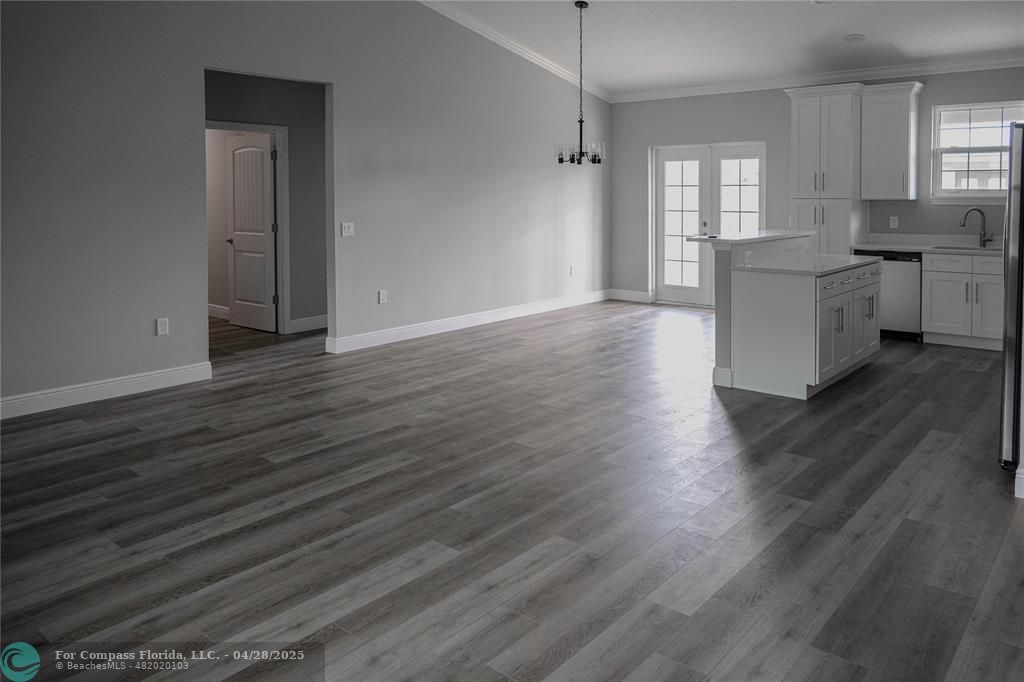 528 Southeast 35th Terrace Okeechobee, FL 34974 - Photo 1 of 4 a view of a kitchen with a sink cabinets and wooden floor