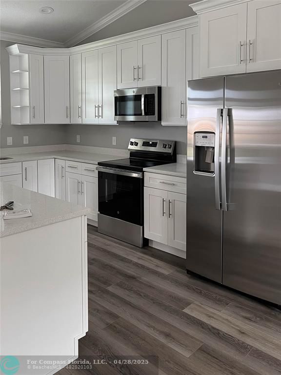 528 Southeast 35th Terrace Okeechobee, FL 34974 - Photo 2 of 4 a kitchen with granite countertop a refrigerator stove and microwave