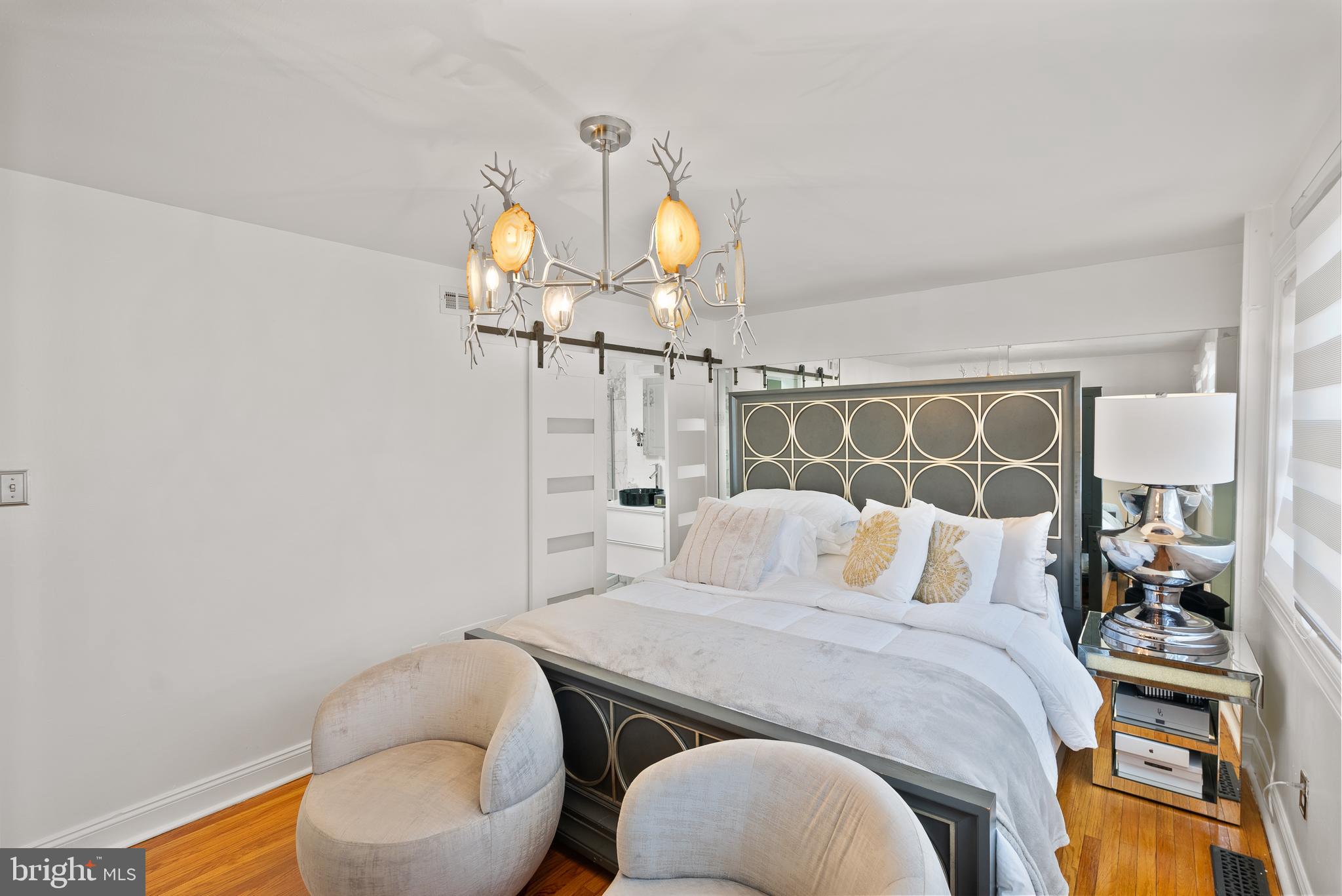 2737 East Country Club Road Philadelphia, PA 19131 - Photo 20 of 24 a bedroom with a bed and a chandelier