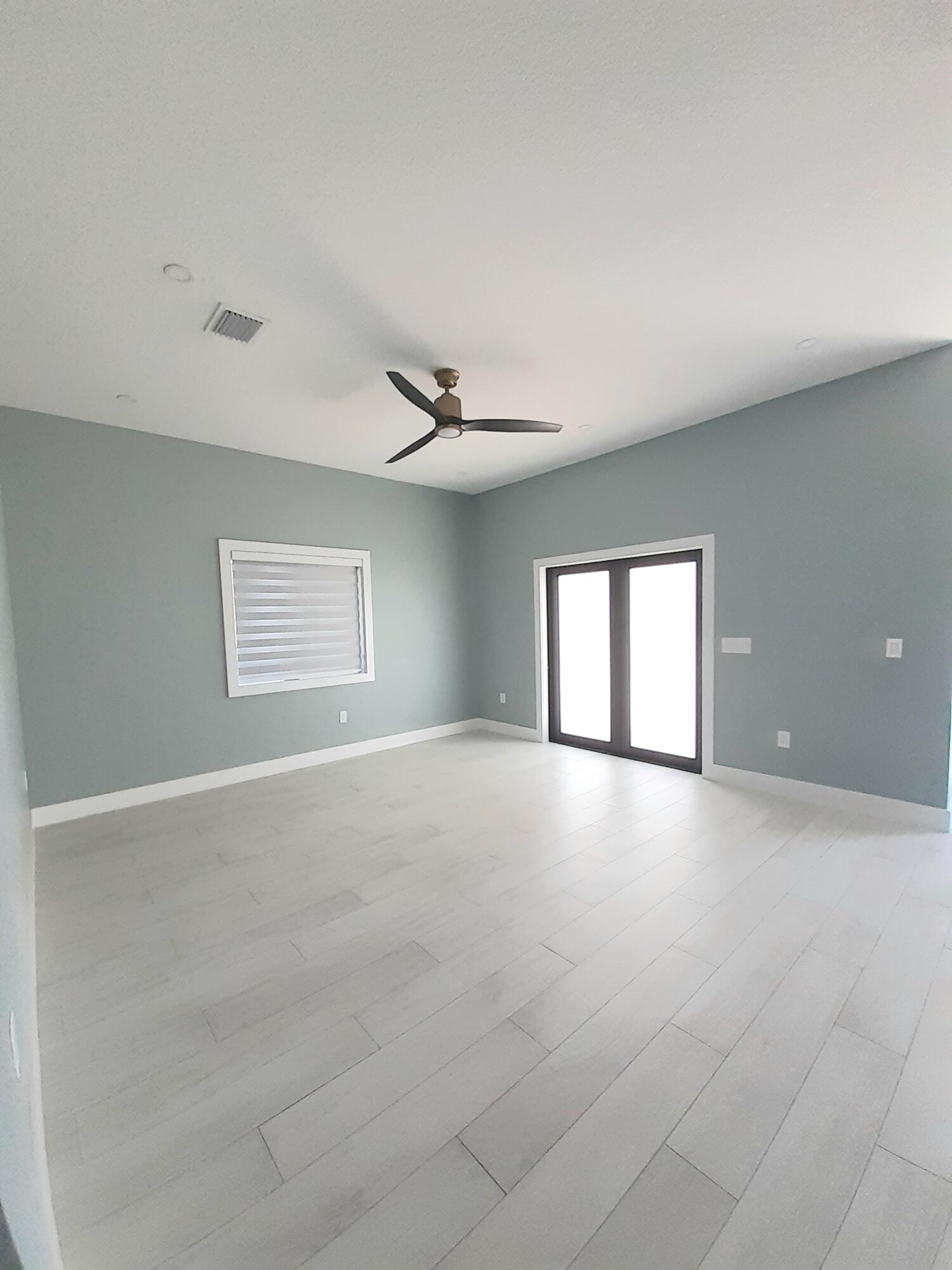 23 Jenny Lane Key Largo, FL 33037 - Photo 2 of 38 an empty room with windows and ceiling fan