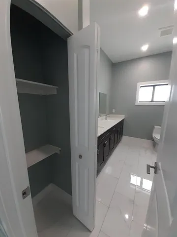 a bathroom with a double vanity sink and a mirror