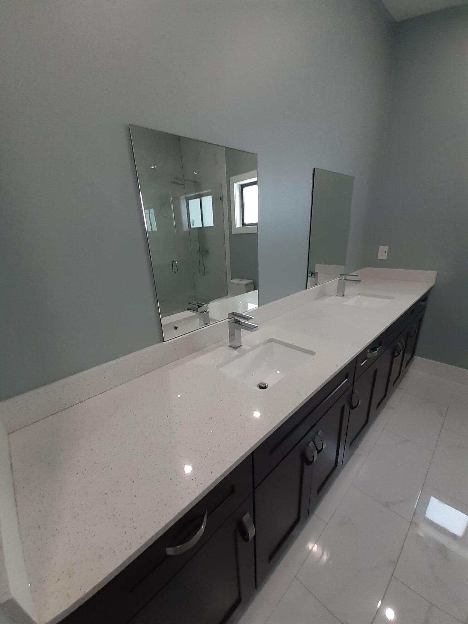 23 Jenny Lane Key Largo, FL 33037 - Photo 30 of 38 a bathroom with a double vanity sink and a mirror