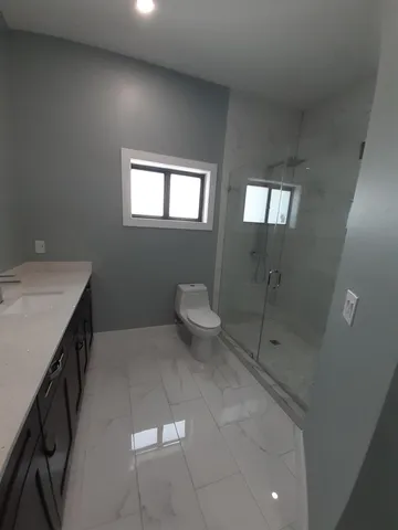 a bathroom with a toilet and a shower