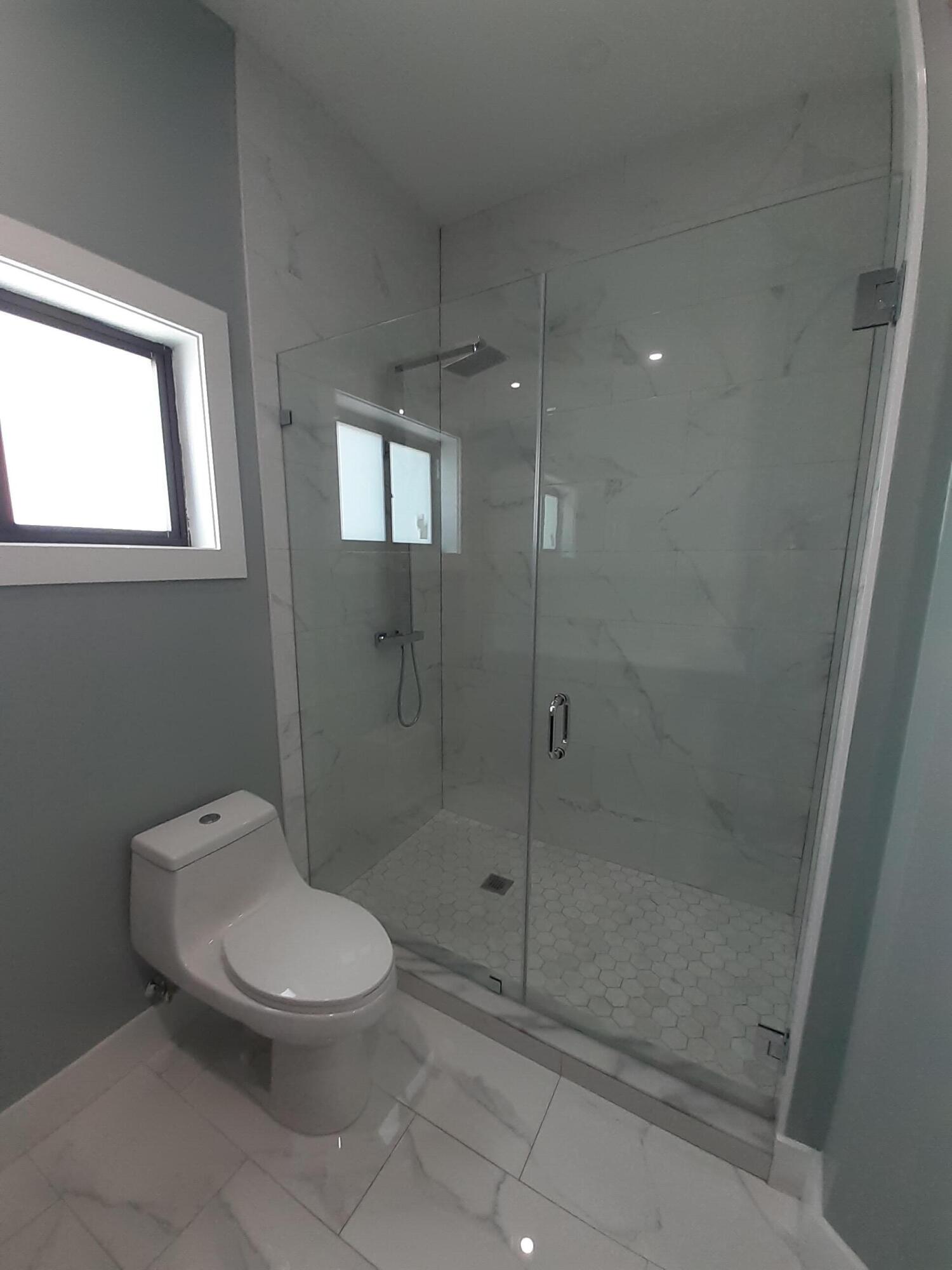 23 Jenny Lane Key Largo, FL 33037 - Photo 32 of 38 a bathroom with a toilet and a shower