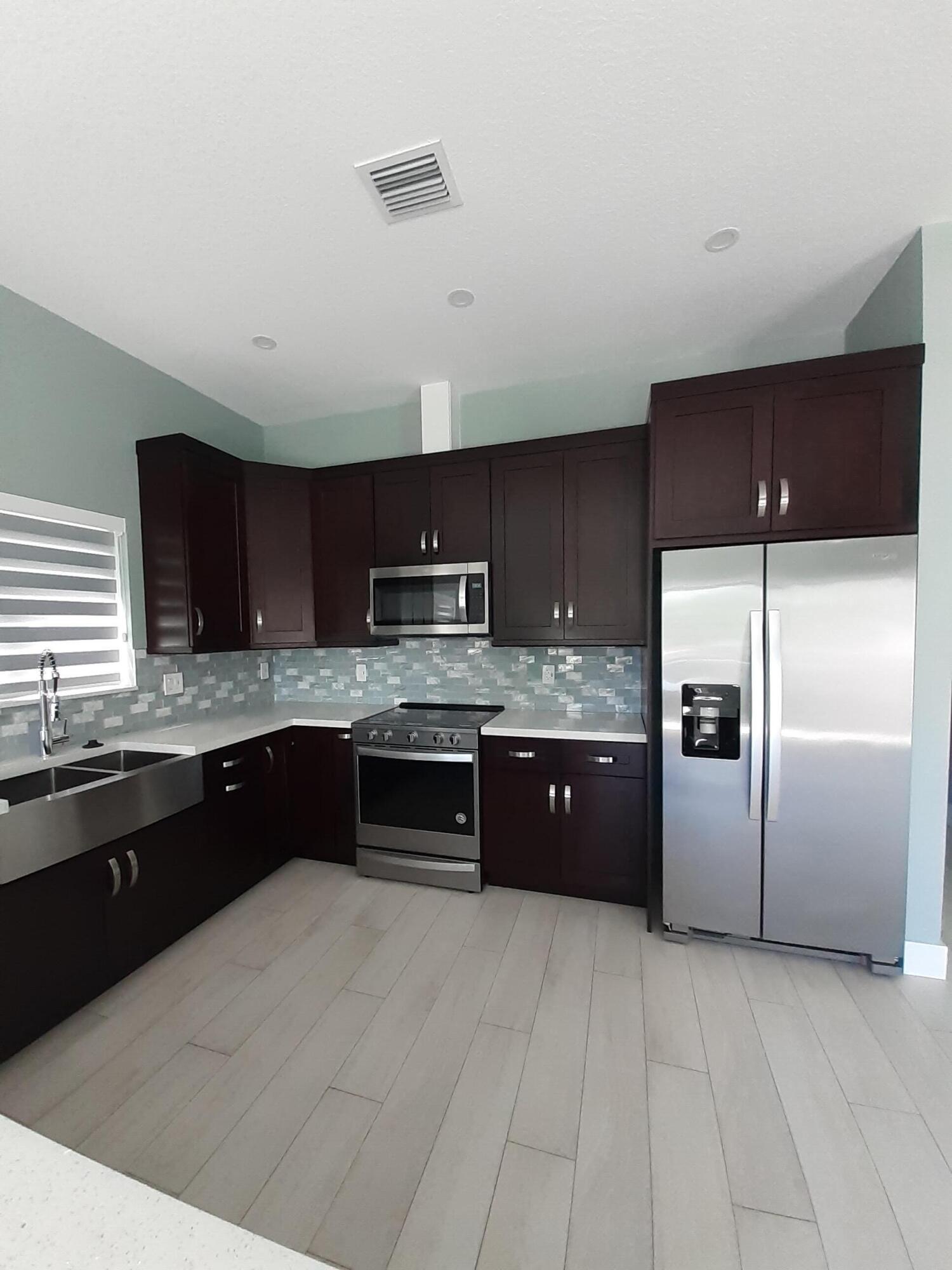 23 Jenny Lane Key Largo, FL 33037 - Photo 7 of 38 a large kitchen with a large counter top stainless steel appliances and cabinets
