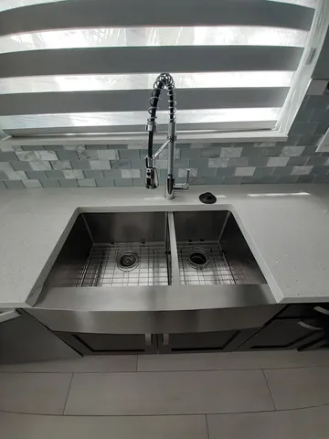 a stove top oven sitting inside of a kitchen