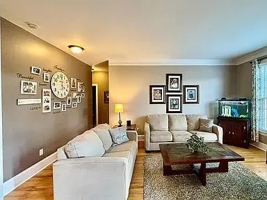 a living room with furniture and wooden floor