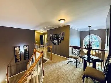 a view of a livingroom with furniture and staircase