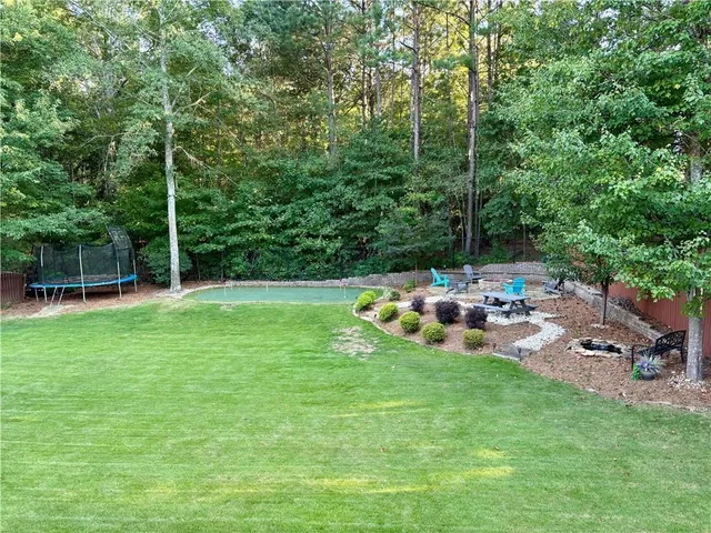 a view of a chair and table on the garden