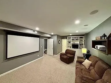 a living room with furniture gym equipment and a large window