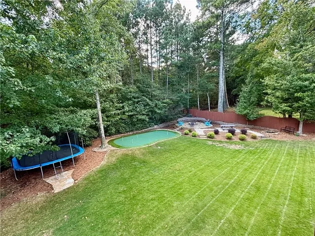 a view of a backyard with swimming pool