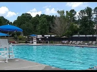 a view of a swimming pool with an outdoor seating