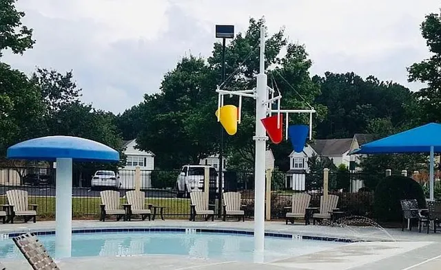 a view of swimming pool with a table and chairs under an umbrella