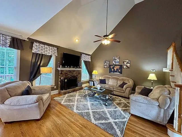a living room with furniture fireplace and a flat screen tv