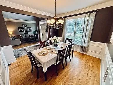 a view of a dining room with furniture window and wooden floor