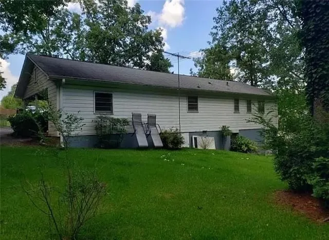 a front view of house with yard and green space