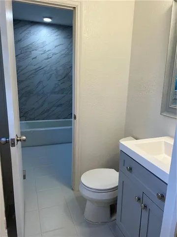 a bathroom with a toilet a sink and vanity