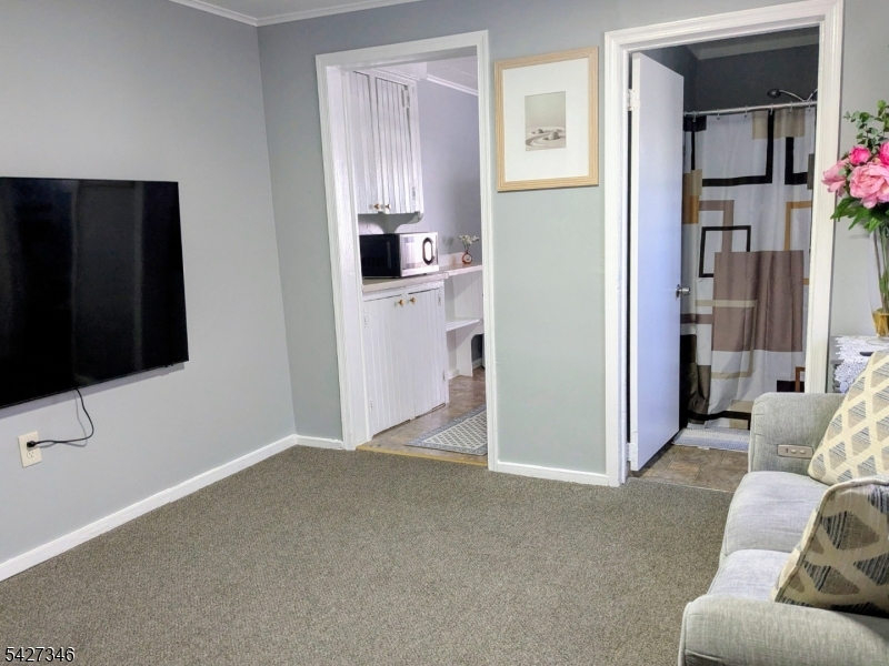 268 Chambers Street, Unit 2 Phillipsburg, NJ 08865 - Photo 3 of 9 a living room with furniture and a flat screen tv