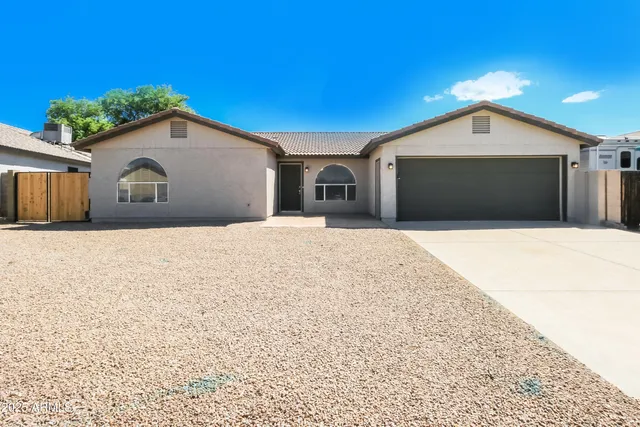 a view of house with yard and kitchen