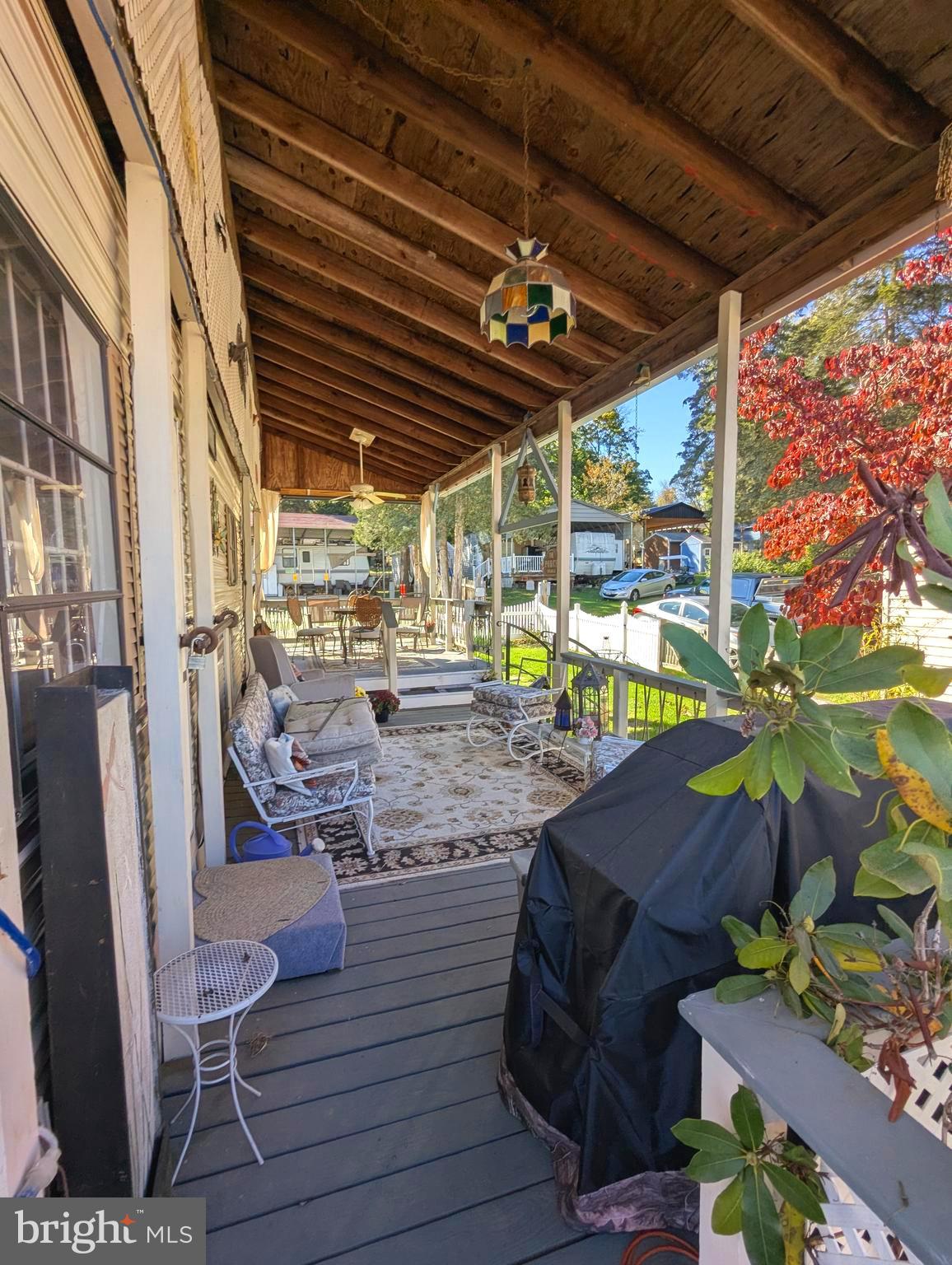 30 & 31 Campfire Boulevard Falling Waters, WV 25419 - Photo 4 of 22 a view of a chairs and table in patio with a wooden fence