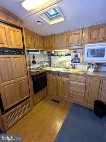 a kitchen with stainless steel appliances a stove a sink and a refrigerator