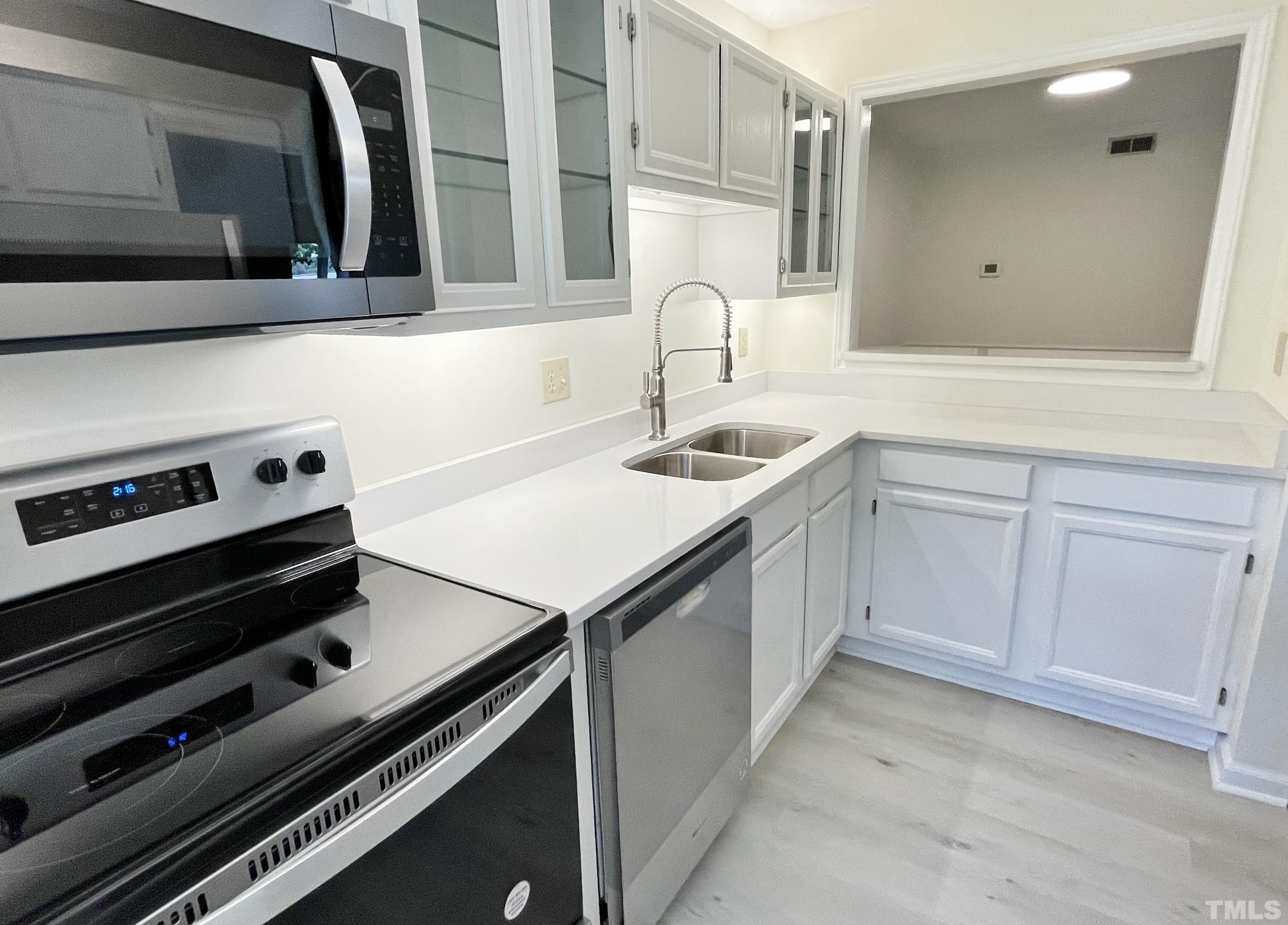 712 Broad Leaf Circle, Unit 712 Raleigh, NC 27613 - Photo 14 of 26 a kitchen with a sink and cabinets