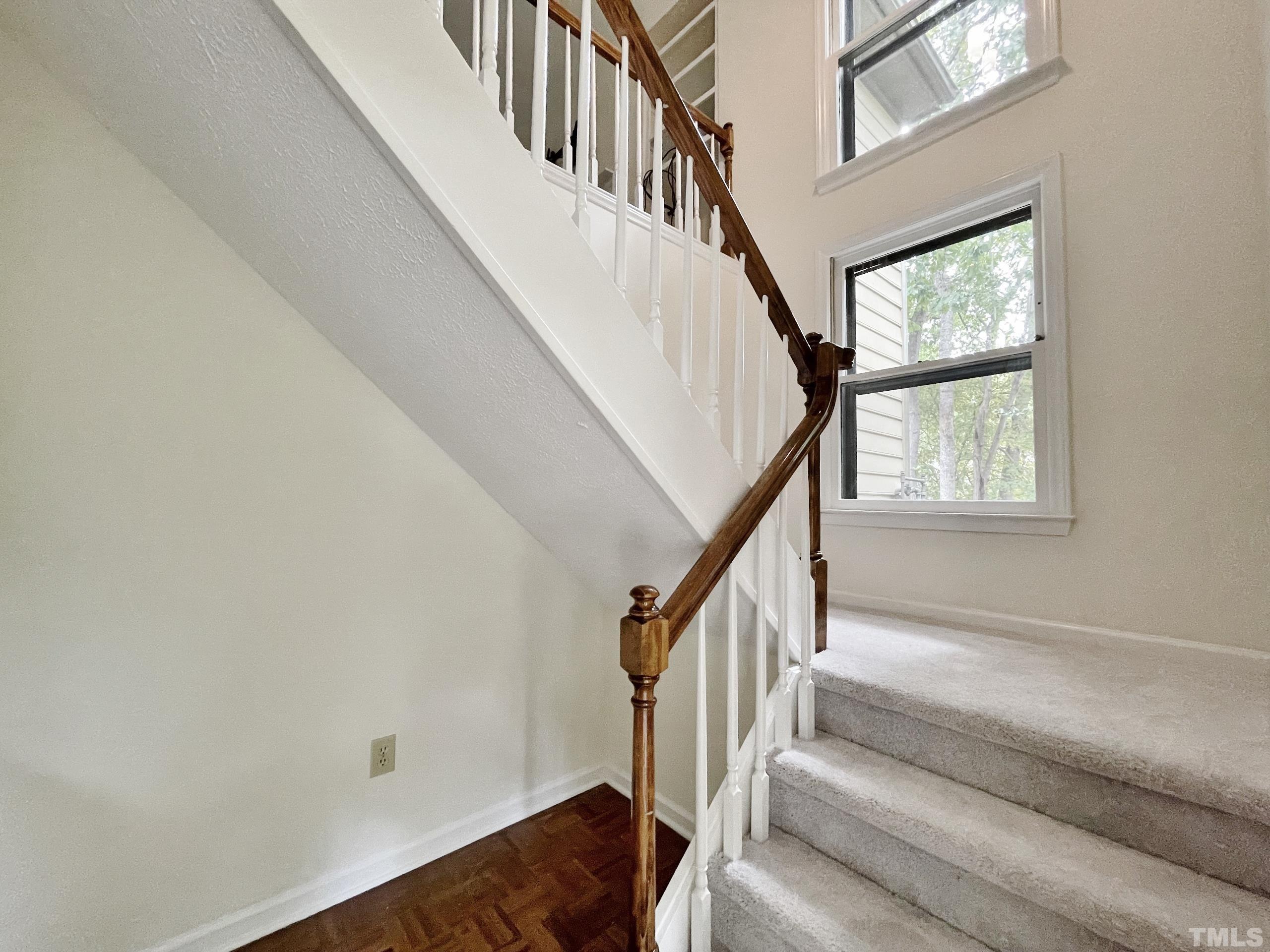 712 Broad Leaf Circle, Unit 712 Raleigh, NC 27613 - Photo 4 of 26 a view of staircase with wooden floor and a window