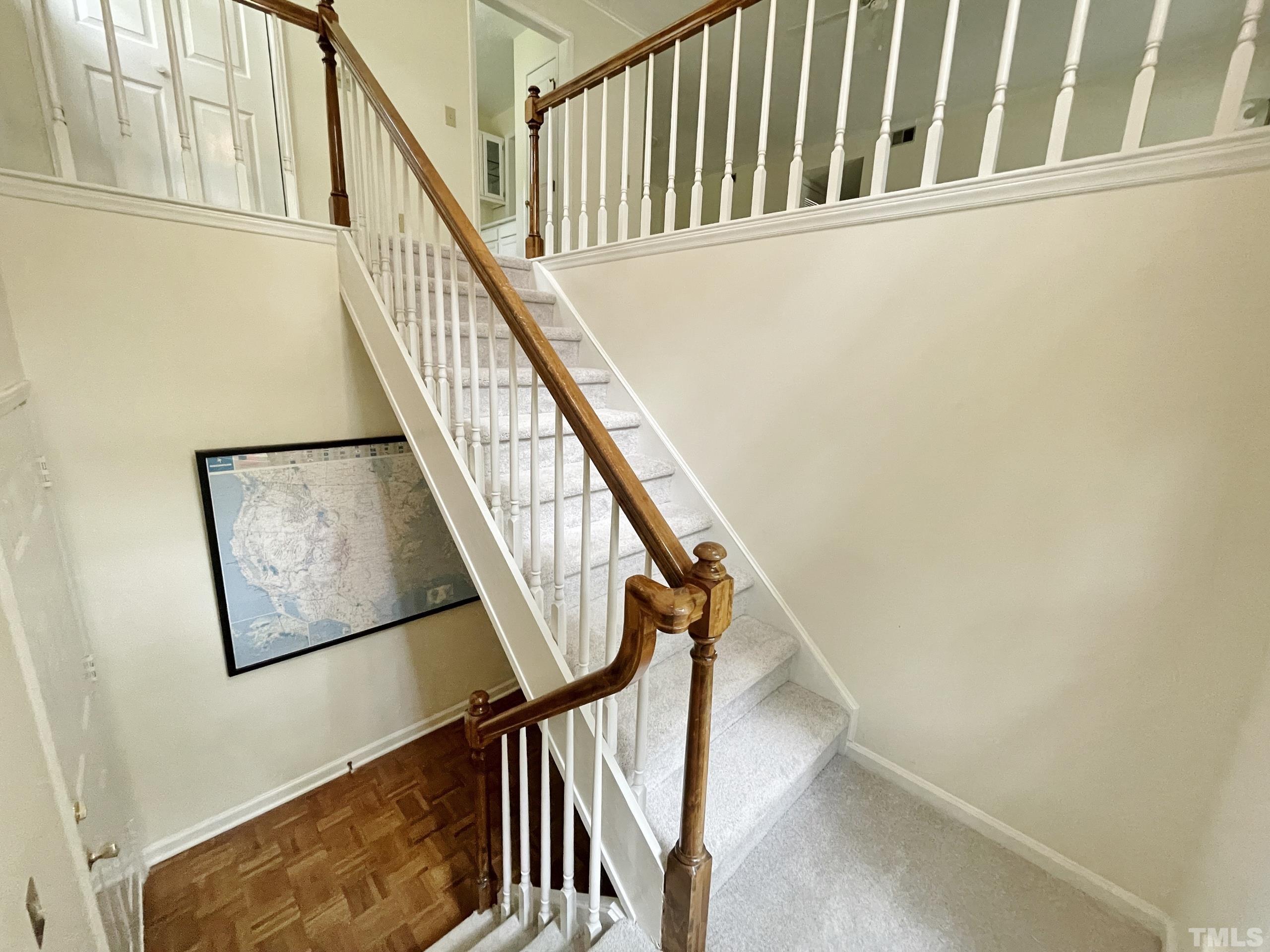 712 Broad Leaf Circle, Unit 712 Raleigh, NC 27613 - Photo 5 of 26 a view of staircase with wooden floor and white walls