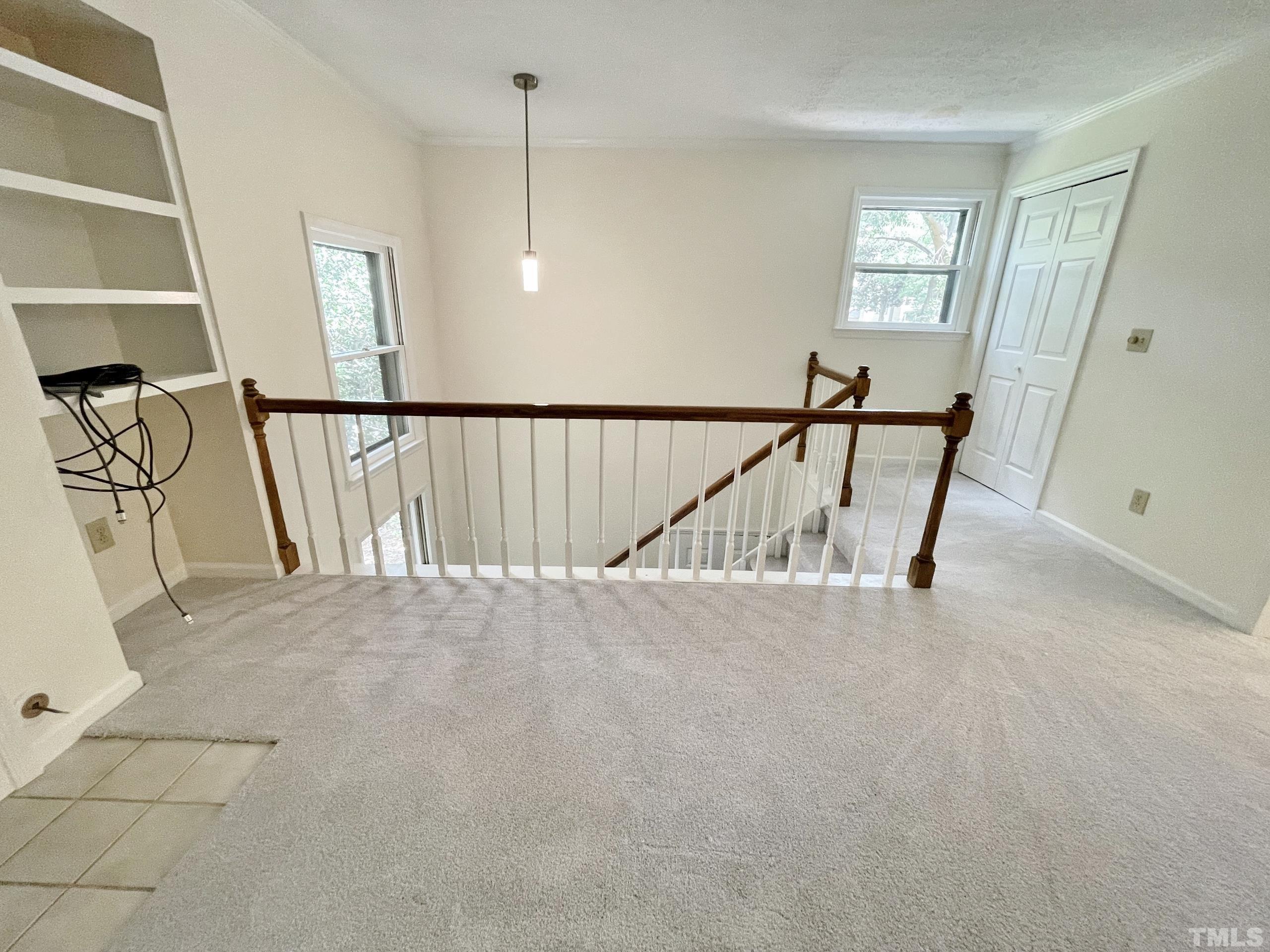 712 Broad Leaf Circle, Unit 712 Raleigh, NC 27613 - Photo 7 of 26 a view of staircase with white walls and a window