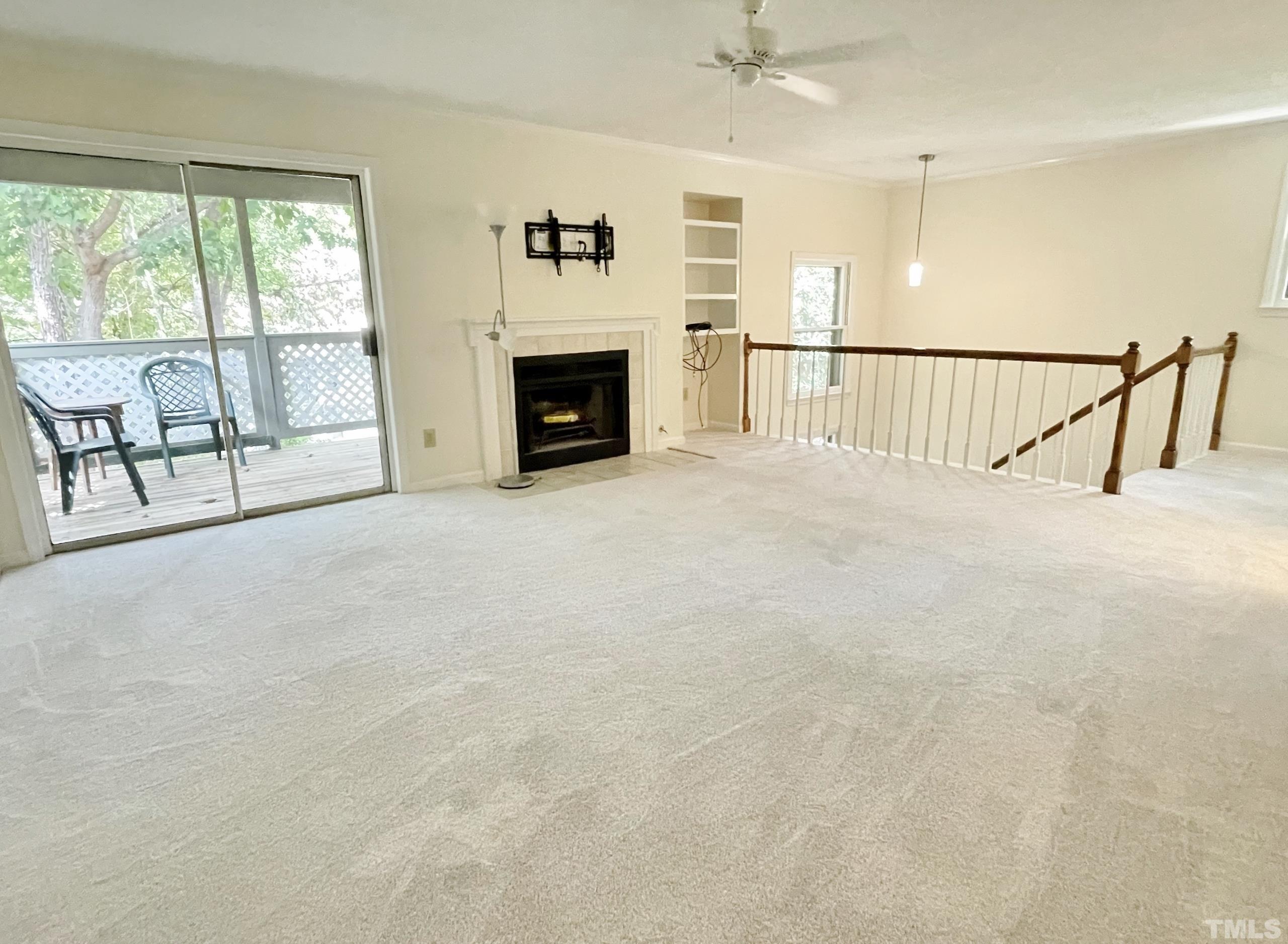 712 Broad Leaf Circle, Unit 712 Raleigh, NC 27613 - Photo 8 of 26 a view of an empty room with fireplace and a window