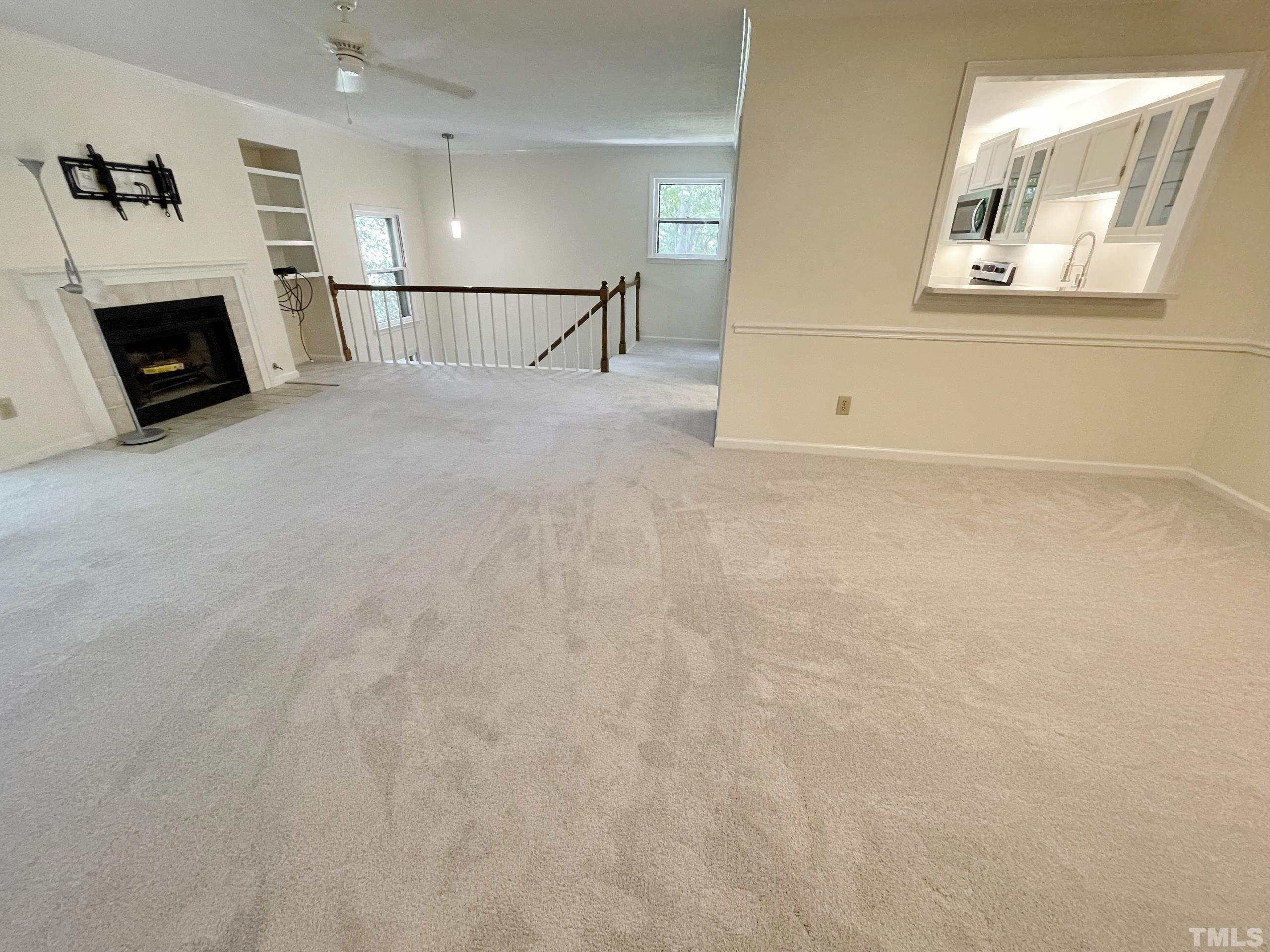 712 Broad Leaf Circle, Unit 712 Raleigh, NC 27613 - Photo 10 of 26 a view of a livingroom with an empty space and a fireplace