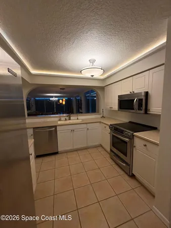 a kitchen with a sink a stove and cabinets