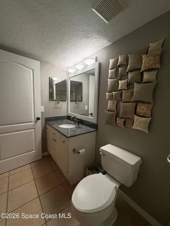 a bedroom with a bed and ceiling fan