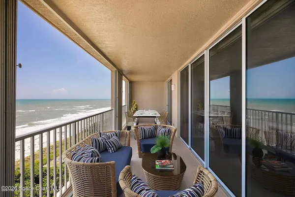 a balcony with furniture and a potted plant