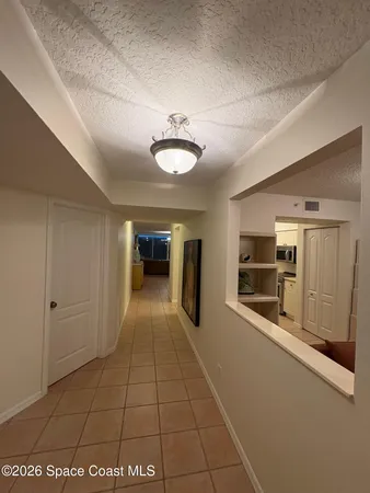 a view of a kitchen with a sink and a refrigerator
