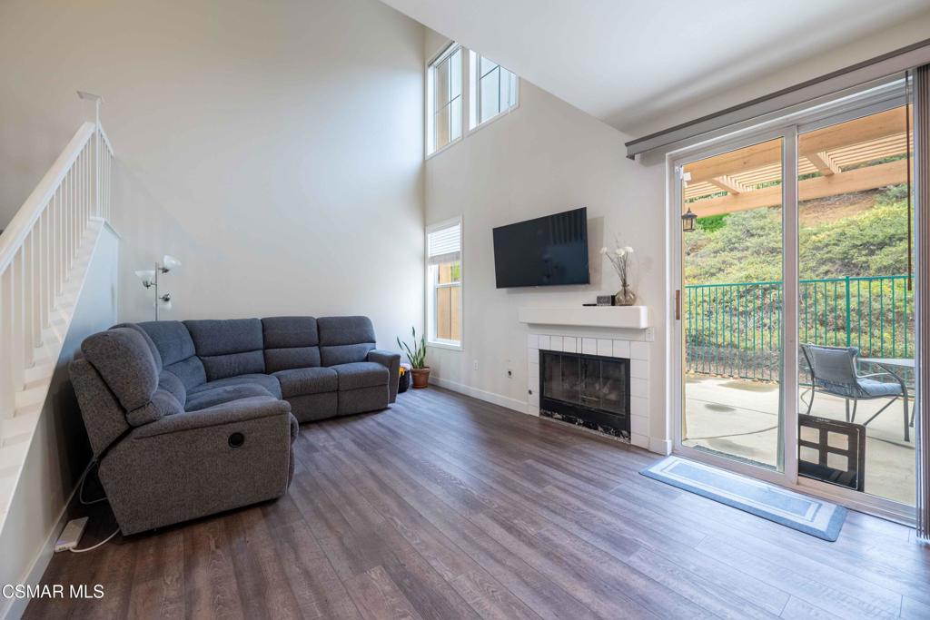 580 Fenwick Way, Unit C Simi Valley, CA 93065 - Photo 6 of 39 a living room with furniture a fireplace and a flat screen tv
