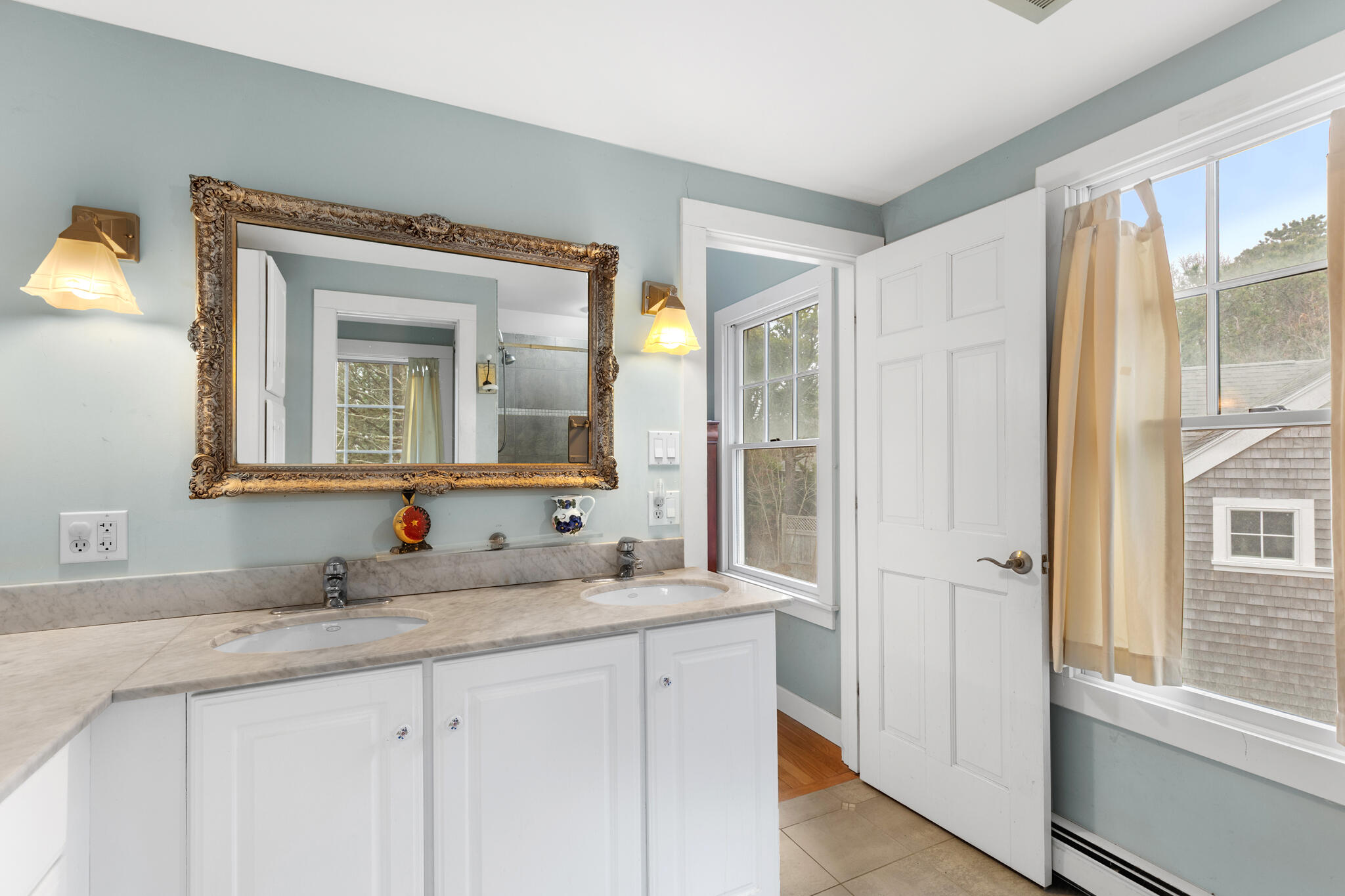 311 South Sunken Meadow Road Eastham, MA 02642 - Photo 43 of 57 a bathroom with a double vanity sink and a mirror