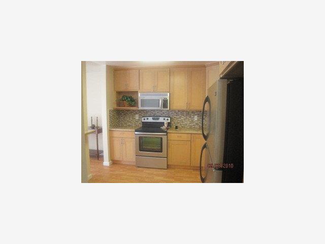 1191 Compass Lane, Unit 108 Foster City, CA 94404 - Photo 2 of 9 a kitchen with a refrigerator and a sink