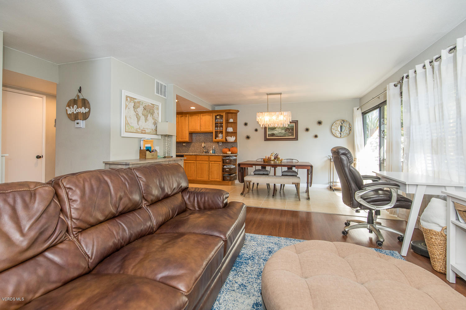 6542 Stoney View Lane, Unit 5 Simi Valley, CA 93063 - Photo 11 of 32 a living room with furniture a dining table and a flat screen tv