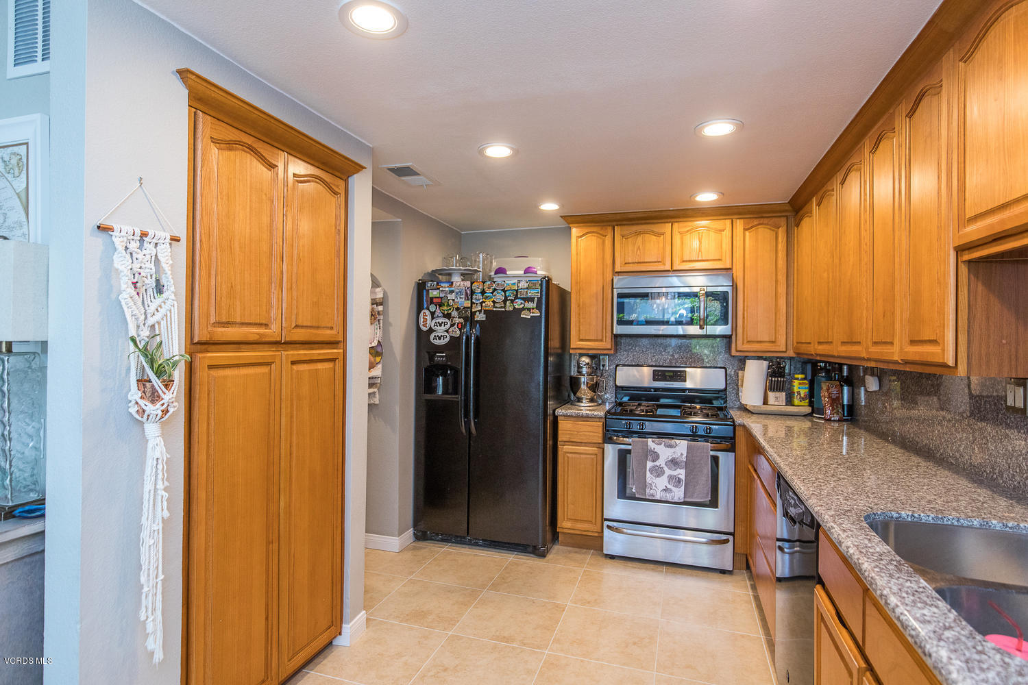 6542 Stoney View Lane, Unit 5 Simi Valley, CA 93063 - Photo 16 of 32 a kitchen with stainless steel appliances granite countertop a refrigerator and a sink