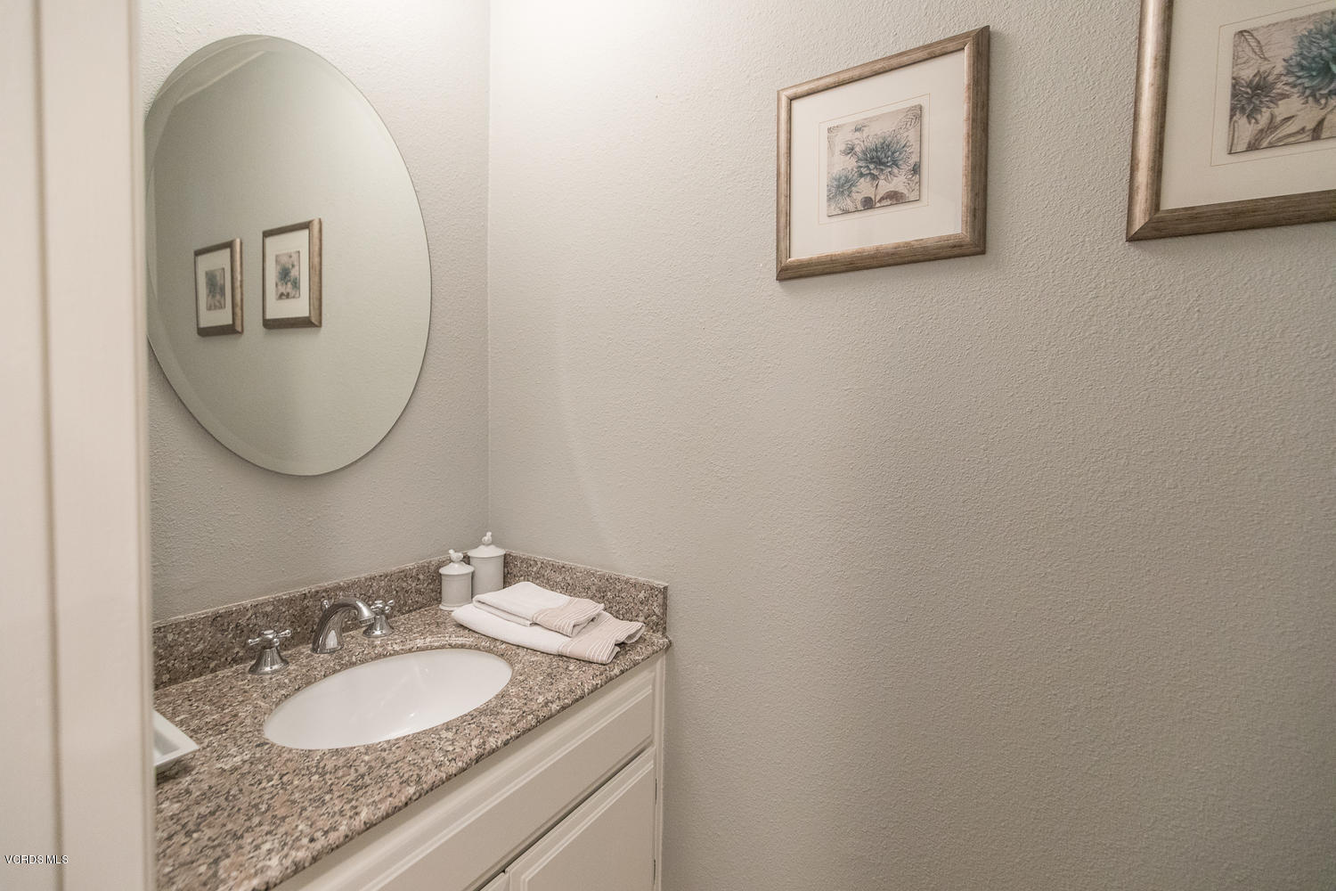 6542 Stoney View Lane, Unit 5 Simi Valley, CA 93063 - Photo 20 of 32 a bathroom with a granite countertop sink mirror and vanity